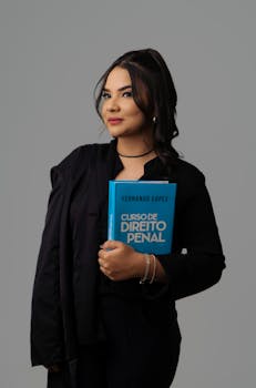 Confident woman posing with a law book against a neutral background. Ideal for educational or legal themes.